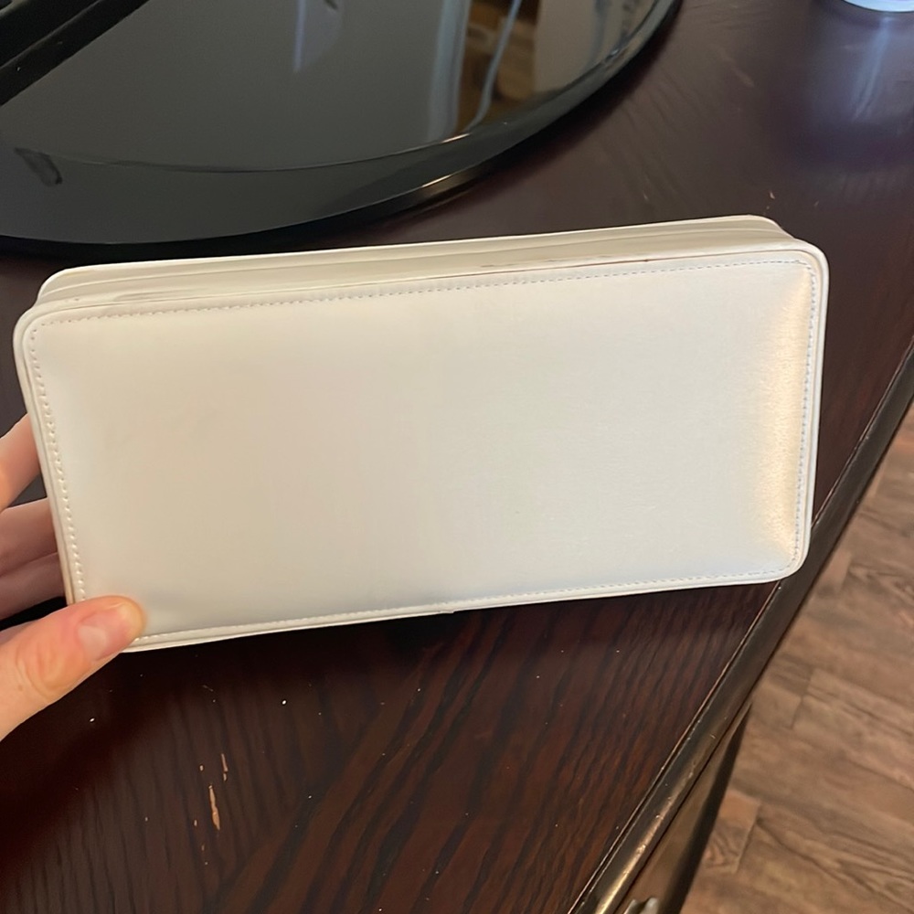 Small cream colored clutch purse